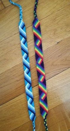 two colorful braided items sitting on top of a wooden floor next to each other