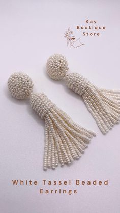 white beaded earrings with tassels