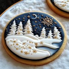 two decorated cookies sitting on top of a plate