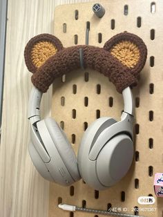 a pair of headphones with ears attached to the ear, hanging on a wall