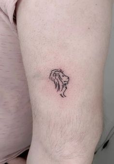 a small lion tattoo on the left thigh