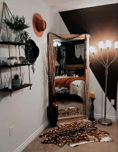 a mirror sitting on top of a floor next to a shelf filled with vases