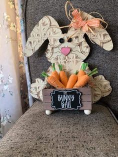 a wooden sign that says bunny bar with carrots in it and a bow on top