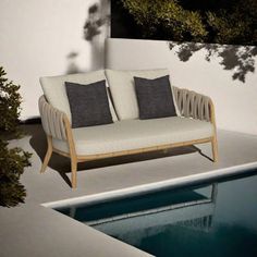 a couch sitting next to a swimming pool