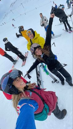 a group of people standing on top of a snow covered slope next to each other