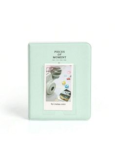 a mint green photo frame sitting on top of a table