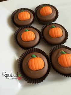 chocolates with frosting decorated like pumpkins on a white plate, ready to be eaten