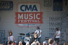 the band cma is performing in front of an audience