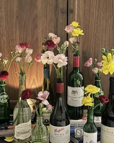 several bottles of wine and flowers on a table