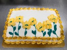 there is a cake with yellow flowers on it