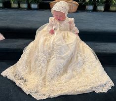 Introducing the Fleur Hand Beaded Christening Gown, a masterpiece of craftsmanship and elegance, meticulously designed for your little angel's significant day. This exquisite ensemble includes not only the breathtaking gown but also a matching bonnet and shoes, ensuring a harmonious and picture-perfect appearance. Each piece of this ensemble has been adorned with hand-placed beading on a lace overlay, creating an effect of ethereal beauty and intricate detail. The sheer lace bell sleeves add a t Baby Christening Outfit, Lace Bell Sleeves, Communion Veils, Girls Communion Dresses, Flower Girl Crown, Girls Crown, Christening Gown, Christening Outfit, Girls Pageant Dresses