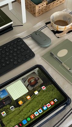 an ipad and keyboard sitting on top of a table