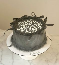 a cake with writing on it sitting on top of a table