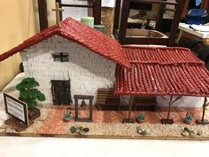 a miniature model of a house made out of clay