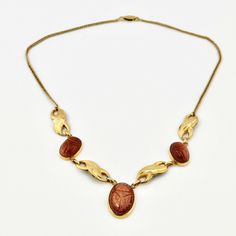 "Rare Ross Simmons 12K GF with Goldstones Scarabs Choker Necklace. Bezel set Scarabs Signed Simmons at the closure. ca 1960s. Measures 15-1/2\"L. The Center Scarab is 3/4\"L. Condition. All The scarabs Intact.  Gold is Intact at the Chain , Scarabs, and the front of Metal Connectors. At the back of the connectors shows a bit patina. Please check out the photos. This Necklace is Rare, Beautiful and much better in person. --------------------------------- In 1952 the first Ross-Simons jewelry store opened in Providence.  Traditionally handcrafted, most of the company's vintage jewelry is made of silver, gold, platinum, and precious and semi-precious stones. According to the marking, the company moved the production to China, supposedly in the 1970s.The vision for Ross-Simons in 1952 is the s Vintage Yellow Gold Cabochon Necklace, Mid-century Gold Jewelry With Cabochon, Mid-century Gold Cabochon Jewelry, Mid-century Oval Gold Jewelry, The Vision, Choker Necklaces, Gold Platinum, Jewelry Store, Bezel Setting