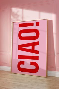 a pink poster with the word caac on it in front of a wooden floor