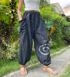 "The harem style trousers made from cotton fabric 100%with an elasticated smock waist and ankles they provide a comfortable lightweight fit, perfect for casual wear, festivals, yoga, holidays as well as pairing with a plain top to get that popular look. Materials: Cotton Sizing: One size fits most. Size : (inches) ✿Waist : 22-42 inch ( 55-106 cm ) ✿ Hip :up to 49 inch ( 124 cm) ✿ Length 40\" ( 101 cm ) ✿2 sides pockets S I Z E : US SIZE 4 - 12 , UK SIZE 8 - 16 , EU SIZE 36 - 44 MODEL SIZE : size Baggy Hippie Harem Pants With Elastic Waistband, Baggy Harem Pants With Elastic Waistband In Hippie Style, Hippie Baggy Harem Pants With Elastic Waistband, Casual Relaxed Fit Harem Pants For Festivals, Bohemian Black Harem Pants With Elastic Waistband, Black Ankle-length Harem Pants With Elastic Waistband, Casual Cotton Parachute Pants For Festival, Summer Cotton Harem Parachute Pants, Cotton Harem Parachute Pants For Summer