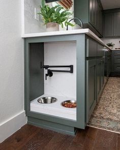 a dog bowl in the corner of a kitchen