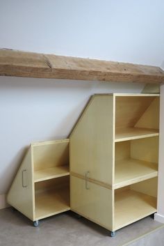 an empty shelf in the corner of a room next to a wooden beam and wall