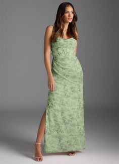 a woman in a green dress posing for the camera