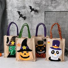 three bags with halloween decorations on them sitting in front of a pumpkin and witch bag