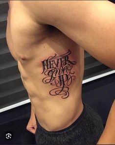 a man with a tattoo on his stomach that says never give up and the words are in cursive font