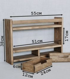 a wooden shelf with drawers next to it and measurements on the wall behind it for storage