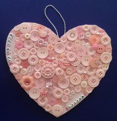 a heart made out of buttons on a blue background