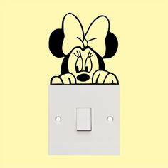 a mickey mouse light switch cover with a cartoon character peeking out from it's side