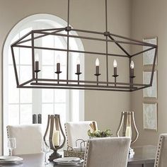 a dining room table with chairs and a chandelier