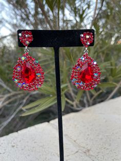 Red Drop Earrings For Party, Red Bling Jewelry For Evening, Glamorous Red Jewelry With Sparkling Stones, Formal Red Sparkling Jewelry, Red Rhinestone Earrings For Formal Occasions, Red Rhinestone Jewelry For Evening, Red Rhinestone Evening Jewelry, Red Crystal Formal Earrings, Formal Red Rhinestone Earrings