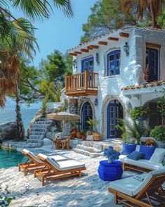 a house on the beach with blue and white furniture