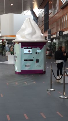 an ice cream vending machine in the middle of a shopping mall