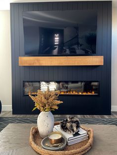 a living room with a fire place and a tv above the fireplace in front of it