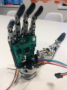 the robotic hand is connected to several wires