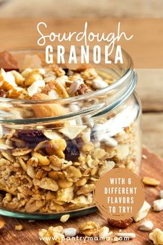 a glass jar filled with granola sitting on top of a wooden cutting board