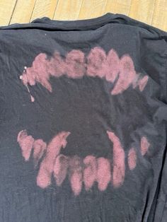 a black shirt with pink ink on it