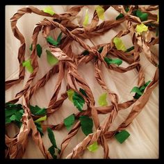 some green leaves and brown paper on a bed