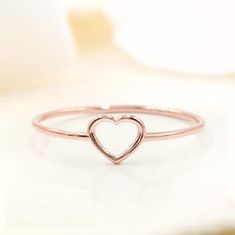 Show your love for her with our shaped dainty ring. It features a light dainty band, and a cute heart shape on top to always remind her of your love. Stack great with our other rings as well! Available in your choice of: Solid 14k & 18K Golds, Silver, or Gold Plated over Silver Base 1.2mm-1.4mm average width Stackable Rose Gold Heart Ring For Valentine's Day, Rose Gold Stackable Heart Ring For Valentine's Day, Dainty Stackable Rose Gold Heart Ring, Heart-shaped Rose Gold Stackable Promise Rings, Valentine's Day Adjustable Rose Gold Stackable Rings, Rose Gold Heart-shaped Midi Rings For Weddings, Minimalist Stackable Rings For Promise On Valentine's Day, Minimalist Stackable Rings For Valentine's Day Promise, Simple Heart Midi Rings