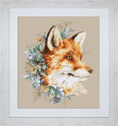 a cross stitch picture of a fox with leaves on it's head, in a white frame