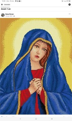 an image of the virgin mary with her hands folded over her chest and wearing a blue shawl