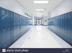 an empty school hallway with blue lockers