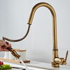 a kitchen faucet that is being used as a sink faucet with water running from it