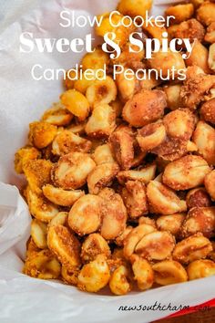 slow cooker sweet and spicy candied peanuts in a white paper bag with text overlay