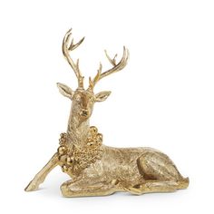 a gold deer figurine sitting on top of a white surface