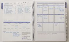 a spiral bound planner is open on top of a white surface with blue writing and numbers