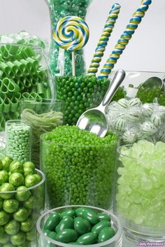 green candies and lollipops in plastic containers