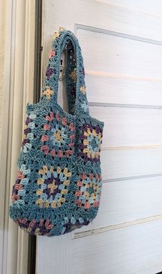 Handmade granny square tote bag Body of the bag measures 14.5 in x 13.75 Handles measure 10 in  Handwash in cold water and soap Not currently lined, but if you would rather it be, then I can do that. Blue Crochet Bag With Granny Square For Everyday, Blue Granny Square Bag For Vacation, Blue Granny Square Shoulder Bag For Daily Use, Blue Granny Square Rectangular Shoulder Bag, Blue Granny Square Shoulder Bag For Everyday, Blue Square Crochet Bag, Blue Square Shoulder Bag For Market, Granny Square Tote Bag, Granny Square Tote