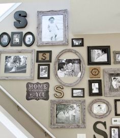 the stairs are decorated with many pictures and letters on them, as well as framed photos