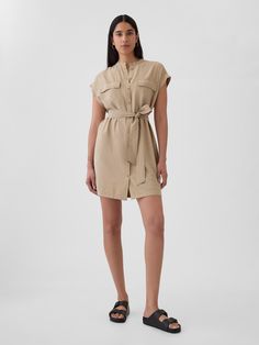 Soft woven utility mini shirtdress.  Crewneck.  Short sleeves.  Button front.  Utility pockets at front.  Tie belt at waist.  Front slant pockets.  *Fit: Slim.  A shift silhouette that's slim & straight through the body.  Hits above the knee.  Model is approx.  5’10” wearing Outfit References, Utility Pockets, Shirtdress, Tie Belt, Above The Knee, New Woman, The Knee, Baby Toddler, Gap